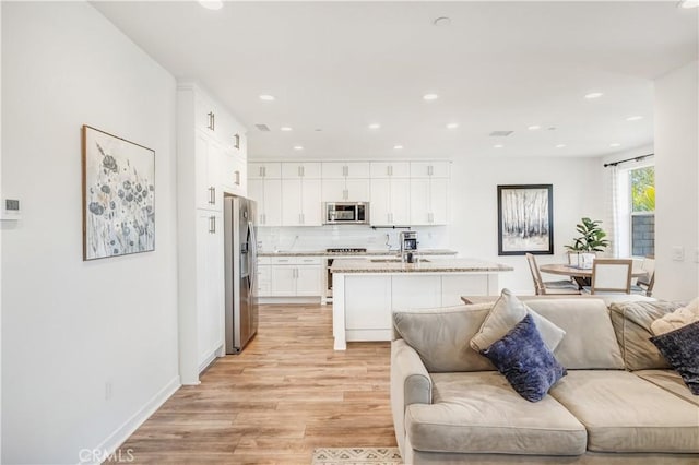 97 Eclipse, Lake Forest, CA 92630 - living room featuring light wood-style floors and recessed lighting