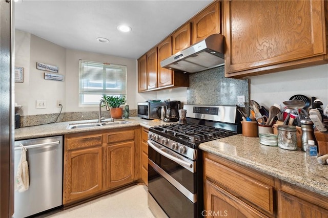 410 N Broadway Unit C, Redondo Beach, CA 90277 - kitchen featuring stainless steel appliances, under cabinet range hood, brown cabinets, light stone counters, and recessed lighting
