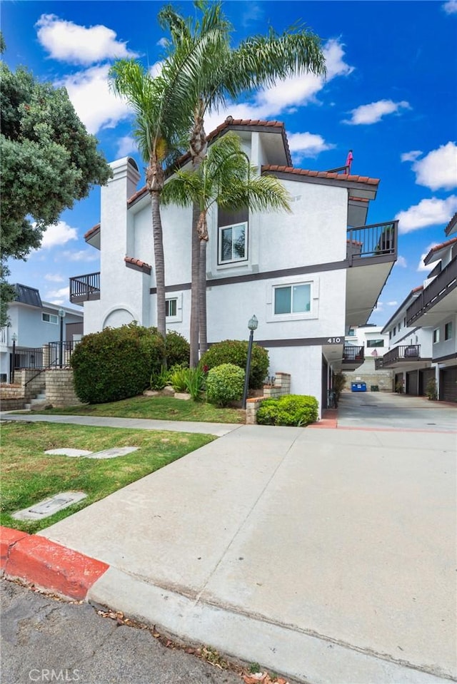 410 N Broadway Unit C, Redondo Beach, CA 90277 - view of front of home featuring a balcony, stucco siding, and a tiled roof