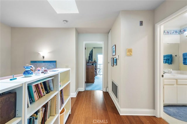 410 N Broadway Unit C, Redondo Beach, CA 90277 - hallway with wood finished floors and a skylight