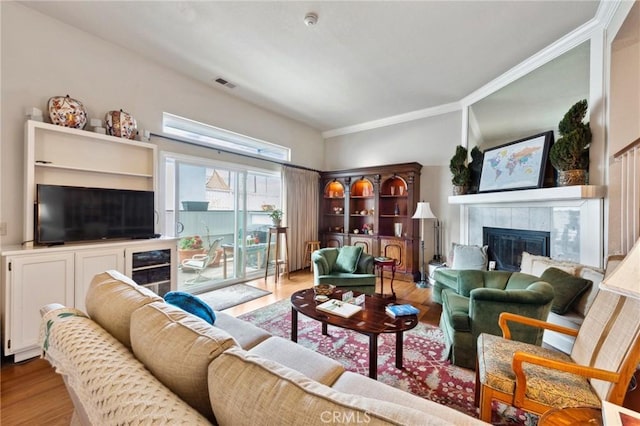410 N Broadway Unit C, Redondo Beach, CA 90277 - living area featuring a fireplace, wood finished floors, and crown molding