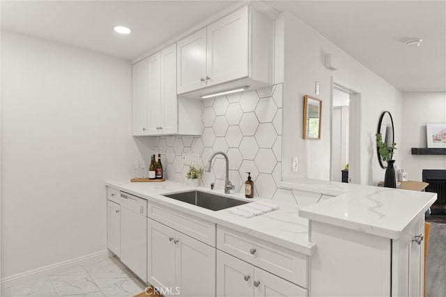 4210 Via Arbolada Unit 105, Los Angeles, CA 90042 - kitchen with dishwasher, white cabinetry, light stone countertops, tasteful backsplash, and recessed lighting