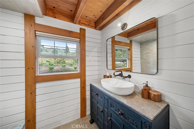 1186 Ramblin Rose Way, Arroyo Grande, CA 93420 - bathroom featuring a wood ceiling with exposed beams, healthy amount of natural light, vanity, wood walls, and tile patterned floors