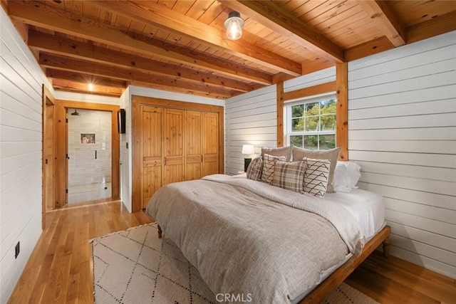 1186 Ramblin Rose Way, Arroyo Grande, CA 93420 - bedroom with wood walls, hardwood / wood-style floors, a wooden ceiling with exposed beams, and a closet