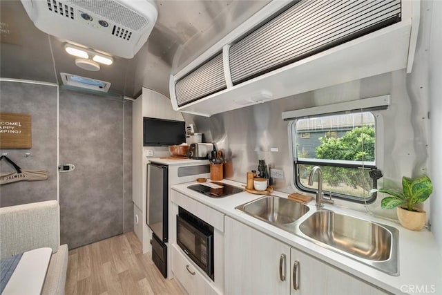 1186 Ramblin Rose Way, Arroyo Grande, CA 93420 - kitchen featuring black microwave, light wood finished floors, light countertops, white cabinets, and stovetop