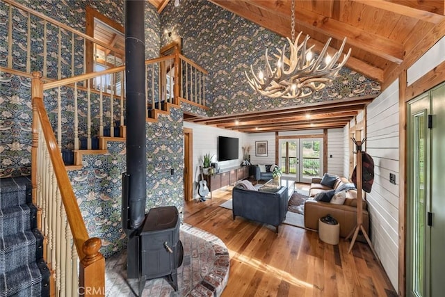 1186 Ramblin Rose Way, Arroyo Grande, CA 93420 - living area with wood finished floors, a chandelier, stairs, a wood stove, and wooden walls