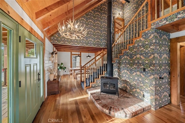 1186 Ramblin Rose Way, Arroyo Grande, CA 93420 - entryway featuring stairway, a wood stove, hardwood / wood-style flooring, a chandelier, and high vaulted ceiling