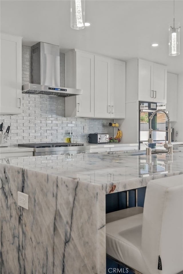 1954 Shipway Ave, Long Beach, CA 90815 - kitchen featuring wall chimney range hood, backsplash, white cabinetry, and recessed lighting