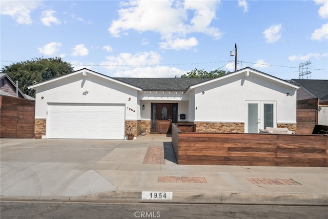 1954 Shipway Ave, Long Beach, CA 90815 - view of front of home with stucco siding, stone siding, french doors, and concrete driveway