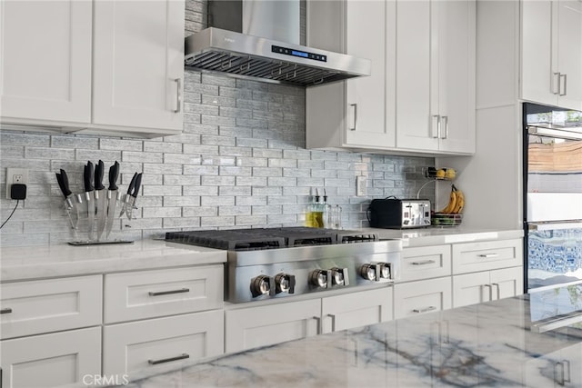 1954 Shipway Ave, Long Beach, CA 90815 - kitchen with wall chimney exhaust hood, appliances with stainless steel finishes, tasteful backsplash, white cabinets, and light stone countertops