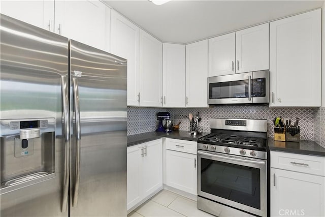 11445 Moorpark St Unit 12, Studio City, CA 91602 - kitchen featuring stainless steel appliances, dark countertops, white cabinets, backsplash, and light tile patterned floors