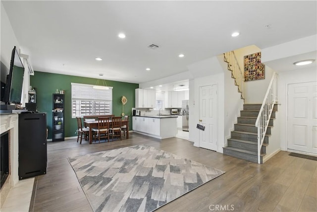 11445 Moorpark St Unit 12, Studio City, CA 91602 - living room with stairs, light wood-style floors, and recessed lighting