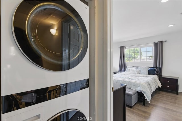 11445 Moorpark St Unit 12, Studio City, CA 91602 - laundry room with stacked washer / dryer, wood finished floors, and recessed lighting