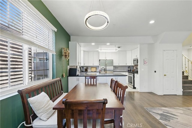 11445 Moorpark St Unit 12, Studio City, CA 91602 - dining space with wood finished floors, stairs, and recessed lighting