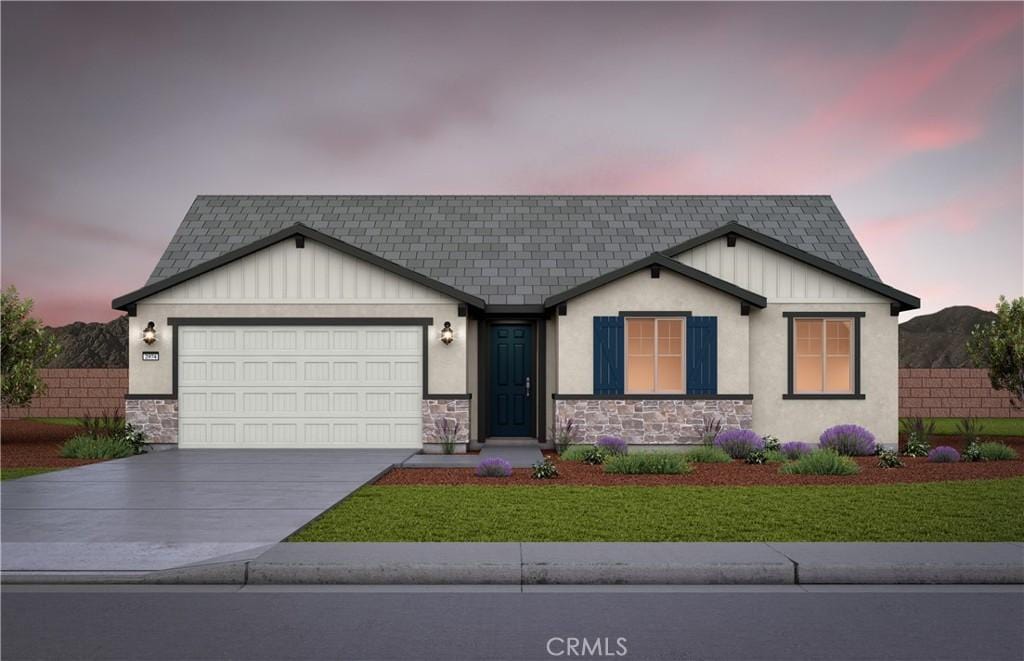 4069 Hudson Ln, Lake Elsinore, CA 92530 - view of front of home featuring an attached garage, concrete driveway, board and batten siding, and a front yard
