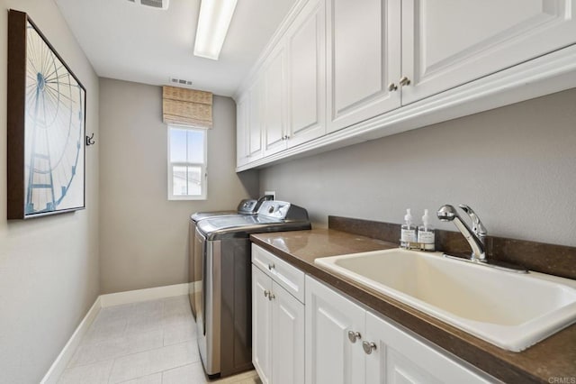 196 Coral Cove Way, Encinitas, CA 92024 - washroom featuring washing machine and dryer, cabinet space, and light tile patterned floors