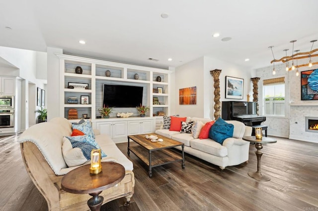 196 Coral Cove Way, Encinitas, CA 92024 - living area featuring a warm lit fireplace, wood finished floors, and recessed lighting