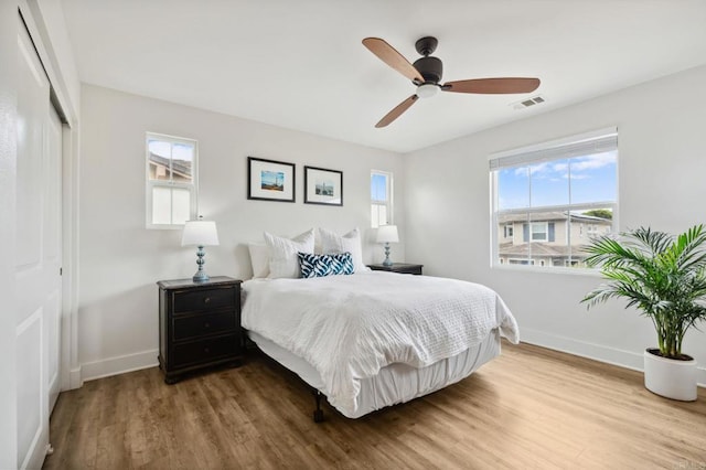 196 Coral Cove Way, Encinitas, CA 92024 - bedroom with wood finished floors, multiple windows, a closet, and ceiling fan