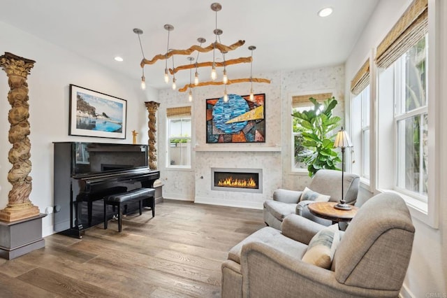 196 Coral Cove Way, Encinitas, CA 92024 - living area featuring a large fireplace, healthy amount of natural light, wood finished floors, and recessed lighting
