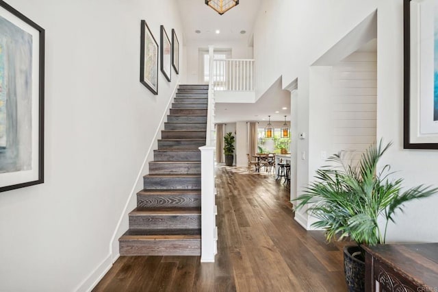 196 Coral Cove Way, Encinitas, CA 92024 - stairway featuring wood finished floors and a towering ceiling