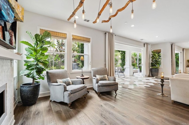 196 Coral Cove Way, Encinitas, CA 92024 - living room with a fireplace, recessed lighting, wood finished floors, and a chandelier
