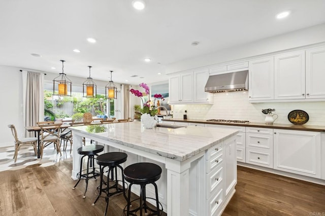196 Coral Cove Way, Encinitas, CA 92024 - kitchen with extractor fan, white cabinetry, tasteful backsplash, dark wood-type flooring, and recessed lighting