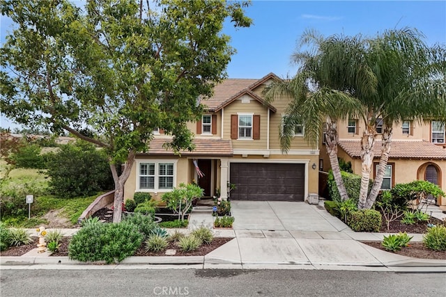 16201 Compass Ave, Chino, CA 91708 - view of front facade featuring a tiled roof, stucco siding, an attached garage, and driveway
