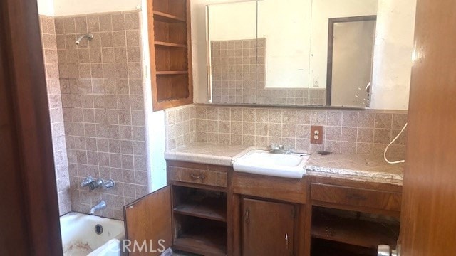38520 12th St E, Palmdale, CA 93550 - bathroom with vanity, tasteful backsplash, and bathing tub / shower combination