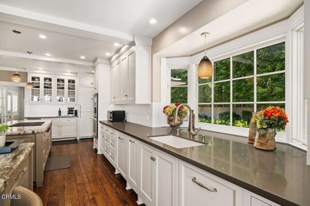 320 N San Rafael Ave, Pasadena, CA 91105 - kitchen featuring white cabinets, backsplash, dark wood finished floors, glass insert cabinets, and recessed lighting