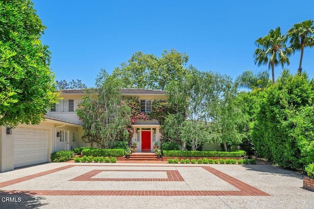 320 N San Rafael Ave, Pasadena, CA 91105 - obstructed view of property with driveway, a garage, and stucco siding