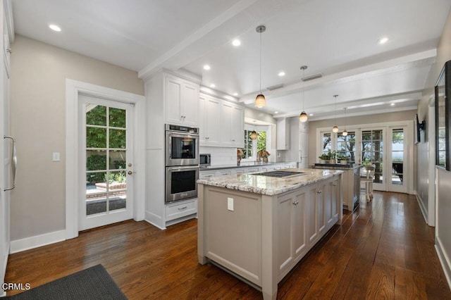 320 N San Rafael Ave, Pasadena, CA 91105 - kitchen with appliances with stainless steel finishes, a center island, dark wood-style flooring, white cabinets, and recessed lighting