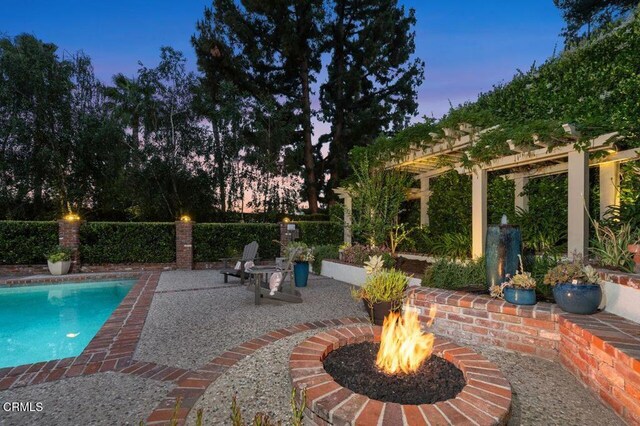 320 N San Rafael Ave, Pasadena, CA 91105 - pool at dusk with an outdoor fire pit, a patio, and a pergola