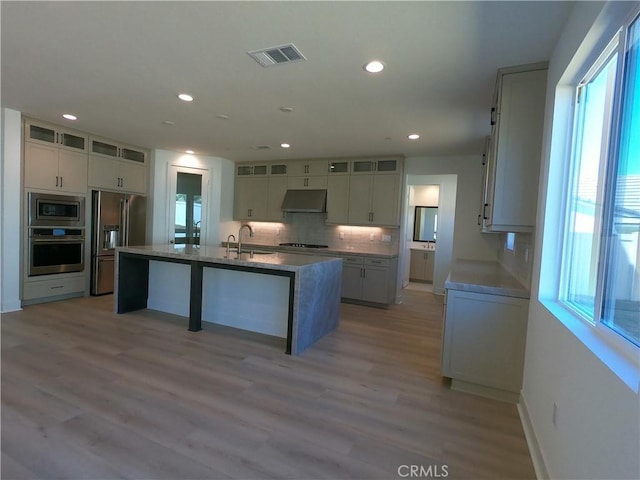 39460 Chamise St, Temecula, CA 92591 - kitchen with stainless steel appliances, healthy amount of natural light, under cabinet range hood, decorative backsplash, and recessed lighting