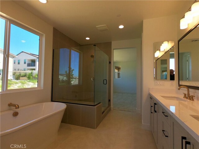 39460 Chamise St, Temecula, CA 92591 - bathroom with double vanity, a freestanding bath, a shower stall, tile patterned flooring, and recessed lighting