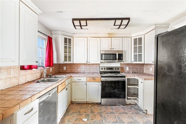 475 Fair Acres, Landers, CA 92285 - kitchen with appliances with stainless steel finishes, tile countertops, tasteful backsplash, and glass insert cabinets