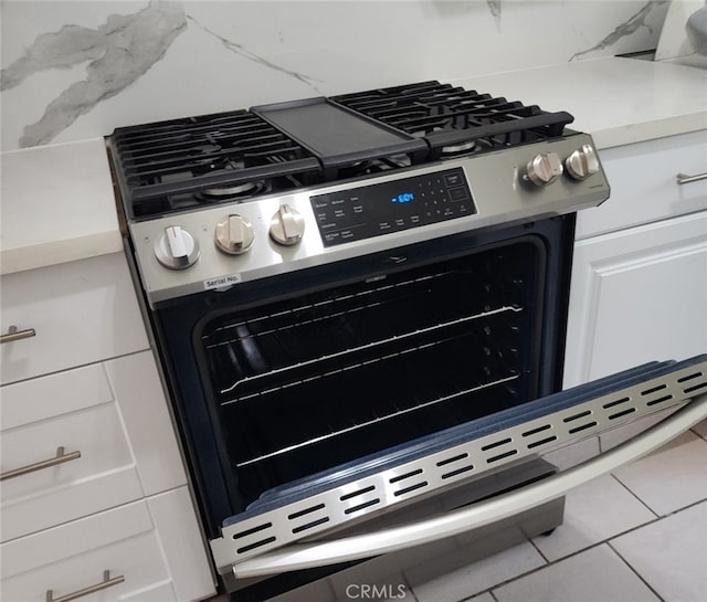 9240 Date St Unit 10A, Fontana, CA 92335 - kitchen view of stainless steel range with gas stovetop, white cabinetry, and light countertops