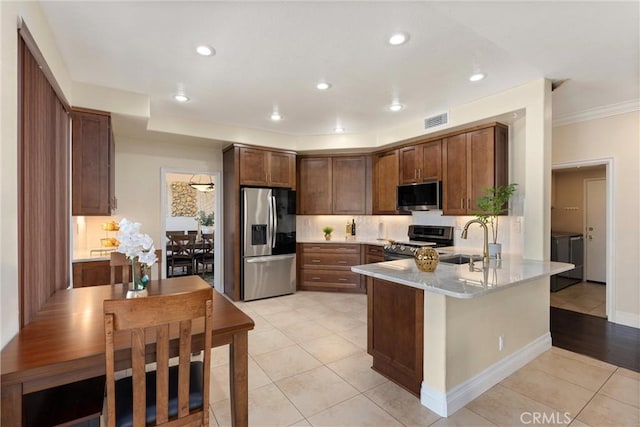 36 Via Tronido, Rancho Santa Margarita, CA 92688 - kitchen featuring stainless steel appliances, a peninsula, light tile patterned floors, light countertops, and recessed lighting