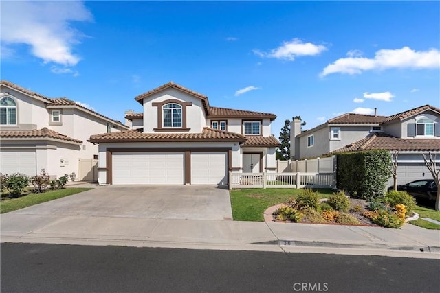 36 Via Tronido, Rancho Santa Margarita, CA 92688 - mediterranean / spanish house featuring driveway, stucco siding, an attached garage, and a tiled roof