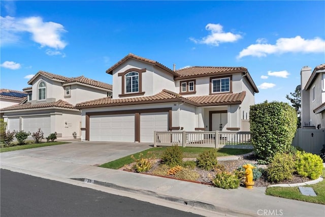 36 Via Tronido, Rancho Santa Margarita, CA 92688 - mediterranean / spanish-style home featuring concrete driveway, stucco siding, a tiled roof, a garage, and covered porch