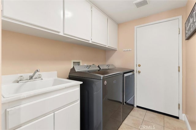 36 Via Tronido, Rancho Santa Margarita, CA 92688 - laundry room featuring cabinet space, washer and dryer, and light tile patterned floors