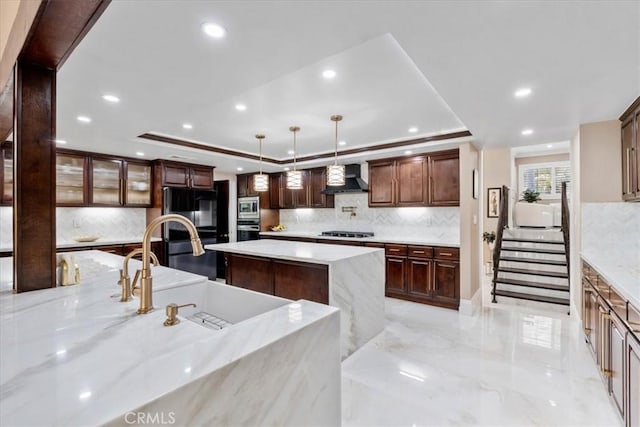 10920 Beechwood Dr, Rancho Cucamonga, CA 91737 - kitchen with wall chimney range hood, appliances with stainless steel finishes, a raised ceiling, decorative backsplash, and recessed lighting