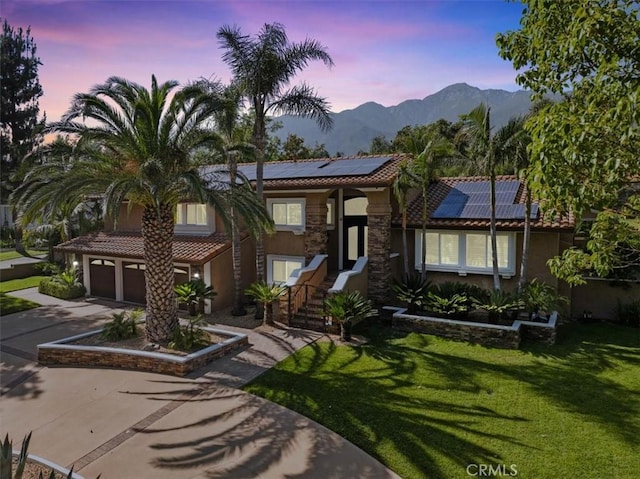 10920 Beechwood Dr, Rancho Cucamonga, CA 91737 - view of front of house with a tiled roof, stucco siding, driveway, a garage, and solar panels
