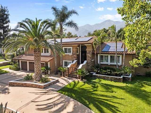 10920 Beechwood Dr, Rancho Cucamonga, CA 91737 - view of front of home with stucco siding, a tile roof, concrete driveway, and roof mounted solar panels