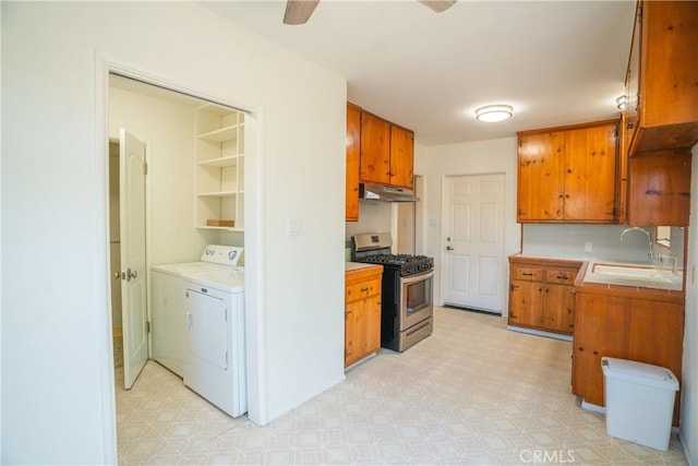 18126 S Denker Ave, Gardena, CA 90248 - kitchen featuring stainless steel gas stove, under cabinet range hood, light floors, and washing machine and dryer