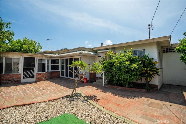 18126 S Denker Ave, Gardena, CA 90248 - rear view of property featuring a patio and brick siding