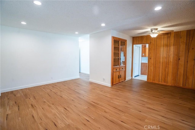18126 S Denker Ave, Gardena, CA 90248 - spare room with light wood-type flooring, a ceiling fan, recessed lighting, wooden walls, and a textured ceiling