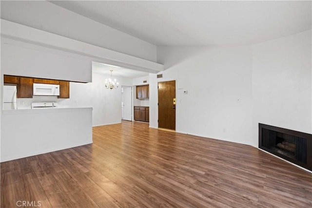 5500 Lindley Ave Unit 206, Encino, CA 91316 - unfurnished living room featuring a chandelier, lofted ceiling, wood finished floors, and a fireplace