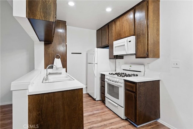 5500 Lindley Ave Unit 206, Encino, CA 91316 - kitchen featuring white appliances, light wood-style floors, dark brown cabinetry, light countertops, and recessed lighting