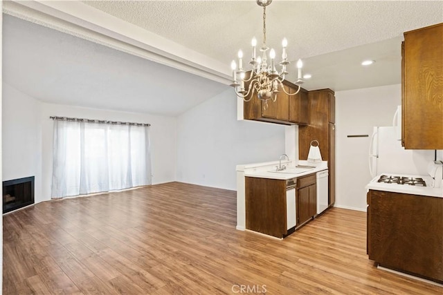 5500 Lindley Ave Unit 206, Encino, CA 91316 - kitchen featuring white appliances, a chandelier, light countertops, light wood-style flooring, and open floor plan