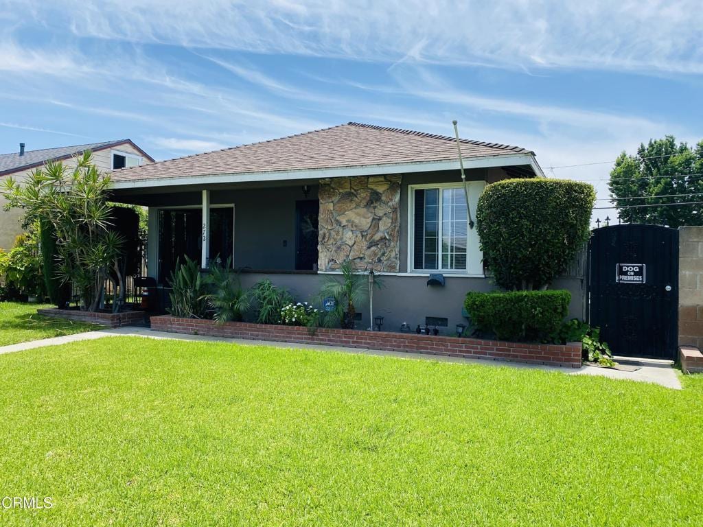 272 E 69th St, Long Beach, CA 90805 - bungalow-style house with a front yard and roof with shingles